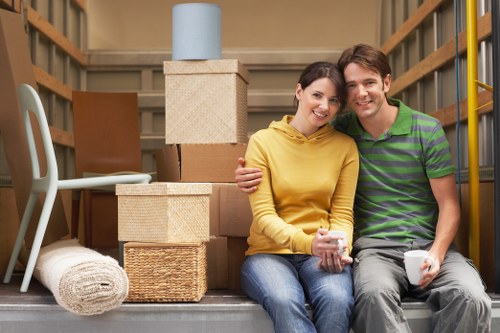 Local movers carrying furniture through a Vauxhall apartment building