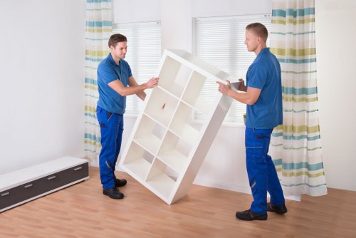 Moving team handling bulky furniture in a Vauxhall apartment building